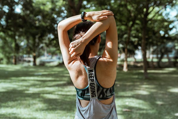 woman outside stretching back