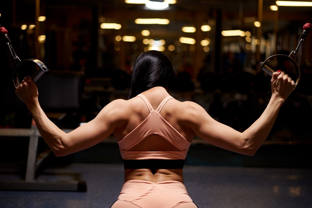 Muscular woman working out in the gym for Compound Movements for Back Strength