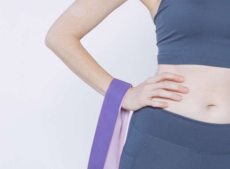lady holding resistance bands