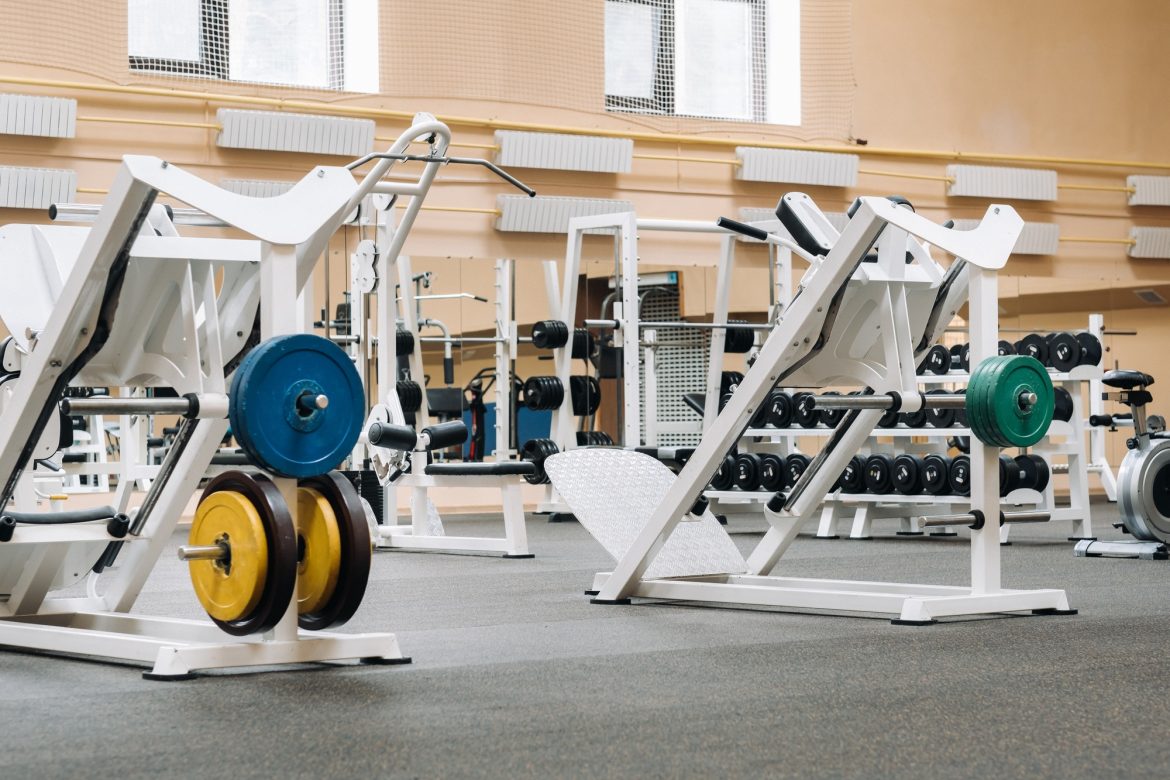 bright gym. Sports equipment in the gym. Bars of different weights on the rack.Trainers