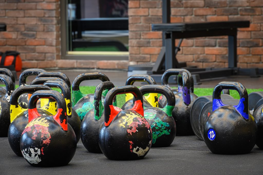 colored kettle bells in gym