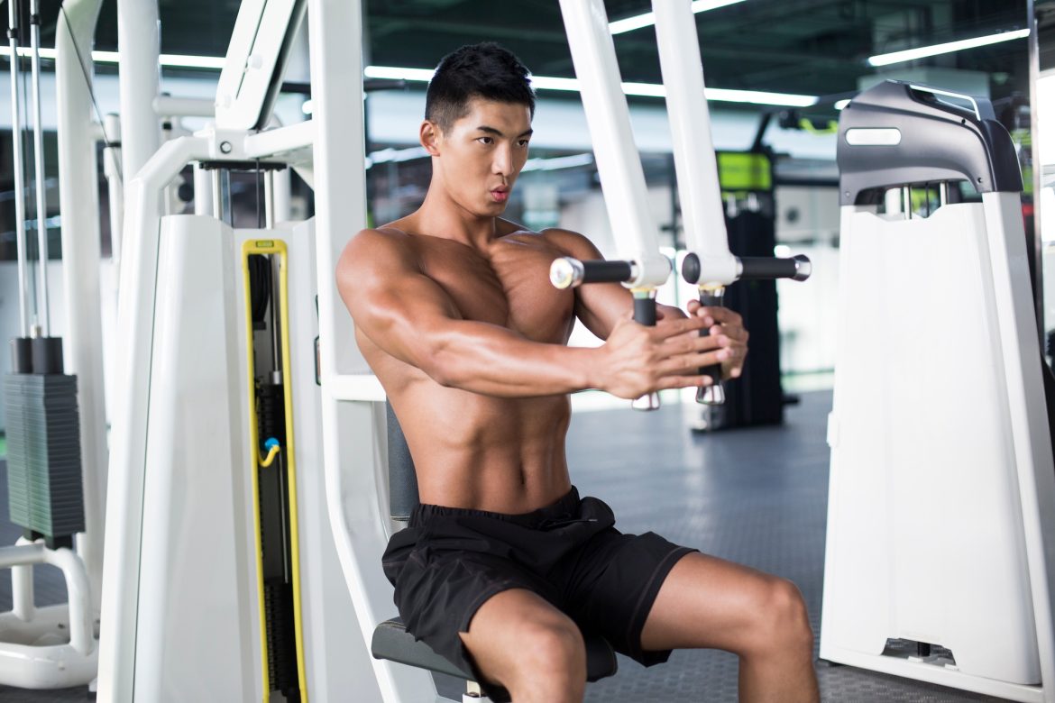 Young man exercising at gym